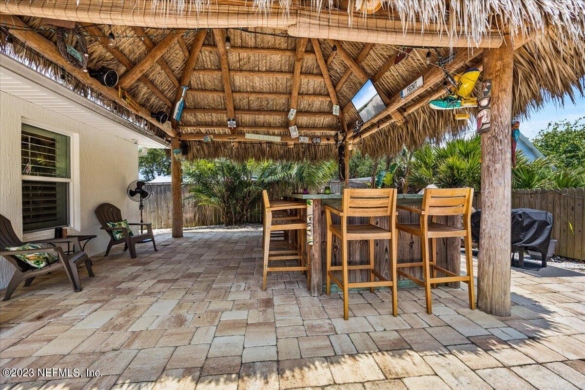 313 Eleventh Street St. Augustine, FL 32084 - Photo 30 of 35 a group of chairs sitting in patio with a fireplace