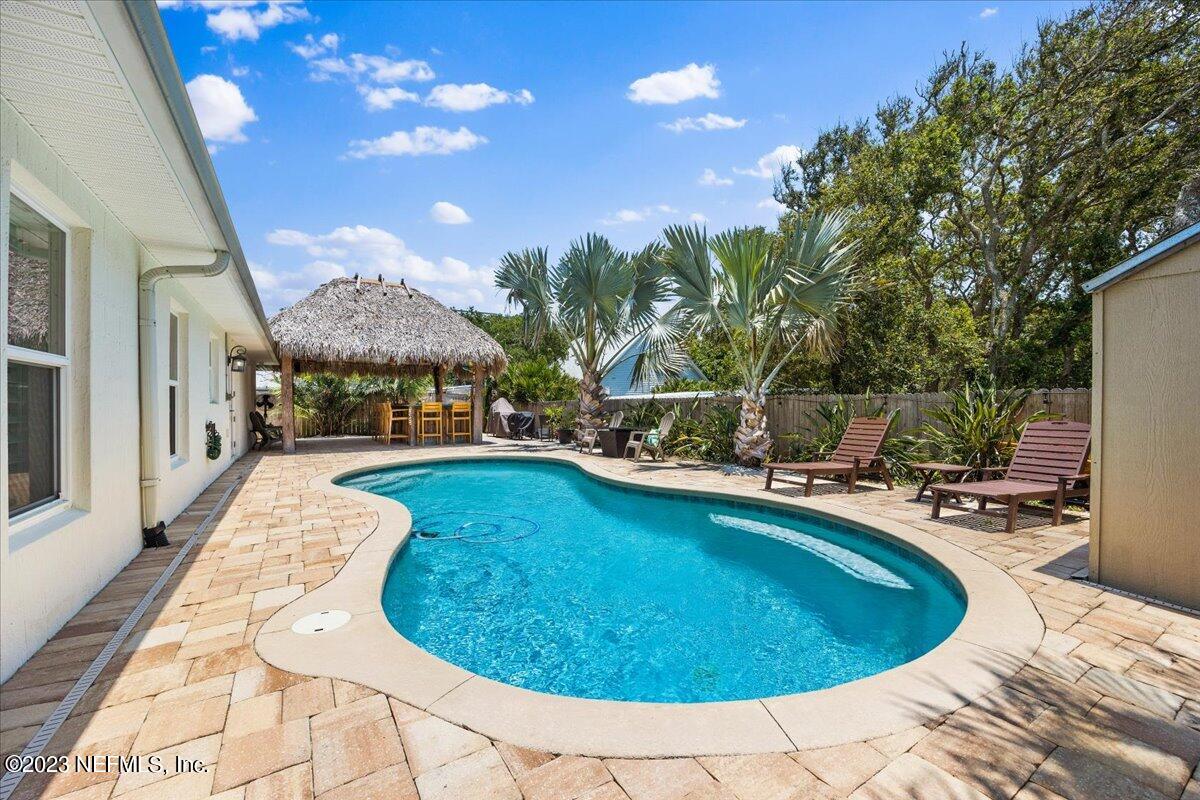 313 Eleventh Street St. Augustine, FL 32084 - Photo 4 of 35 a swimming pool with outdoor seating and yard