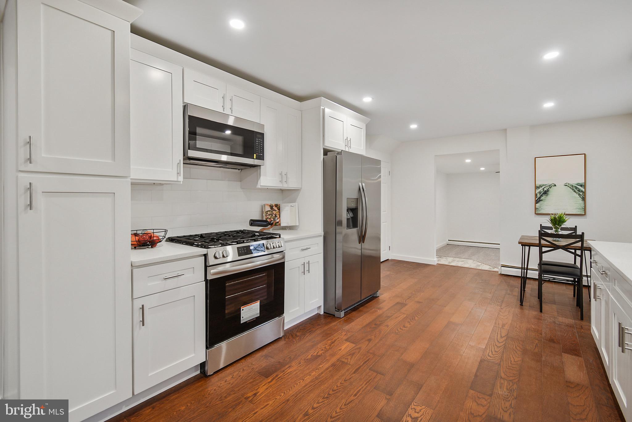 421 Concord Avenue Exton, PA 19341 - Photo 11 of 38 a kitchen with stainless steel appliances a stove a microwave and a refrigerator