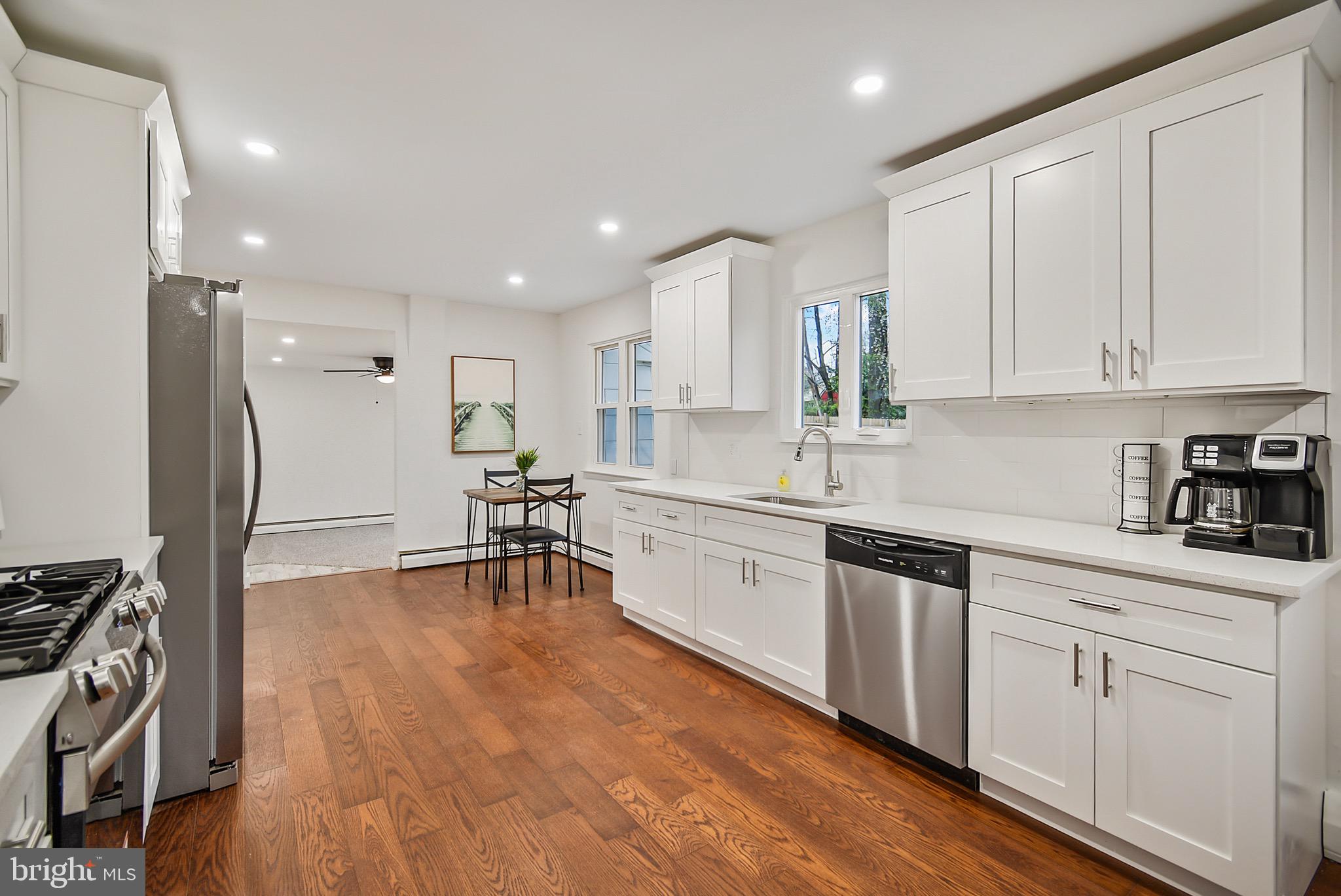 421 Concord Avenue Exton, PA 19341 - Photo 12 of 38 a kitchen with white cabinets and stainless steel appliances