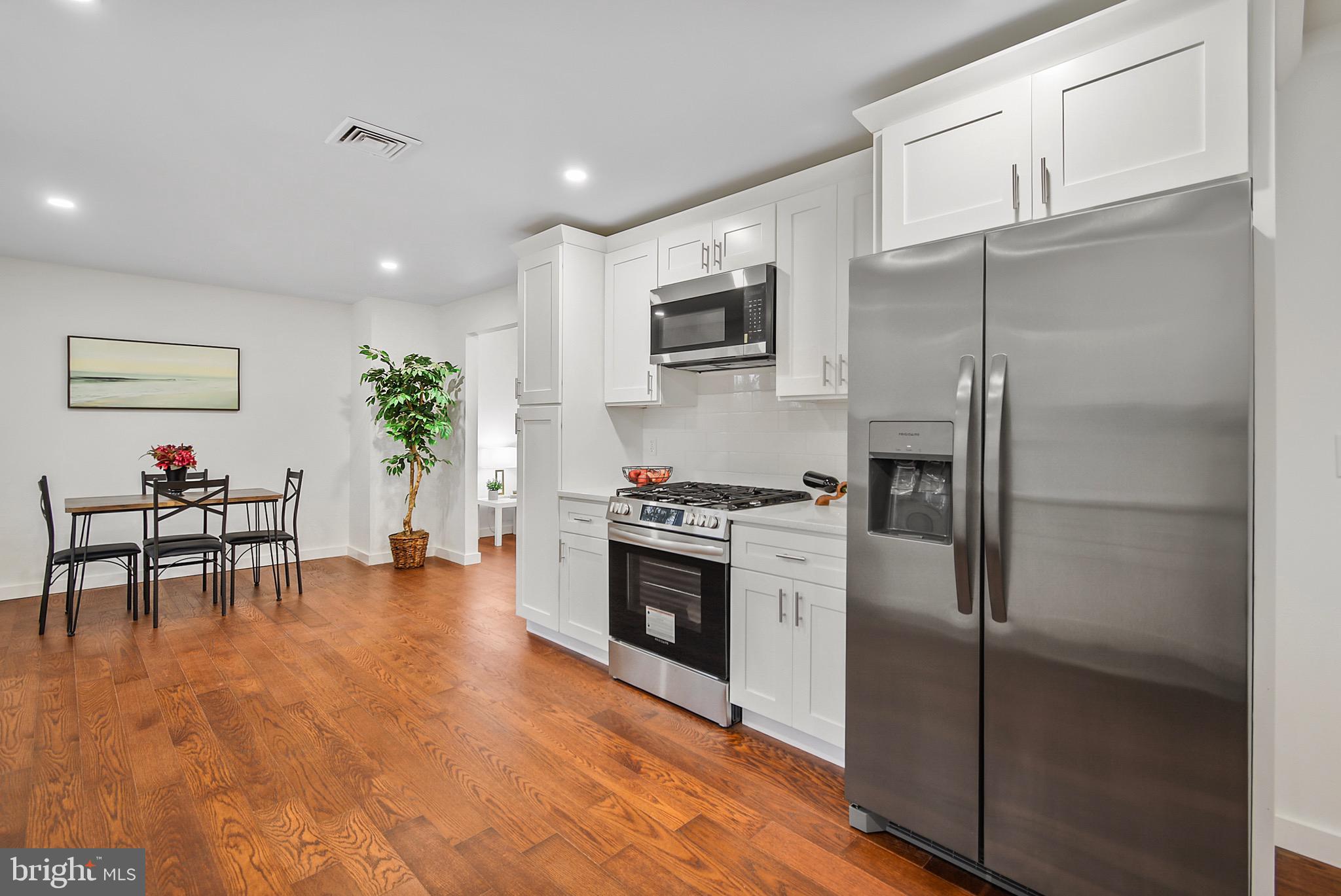 421 Concord Avenue Exton, PA 19341 - Photo 14 of 38 a kitchen with stainless steel appliances granite countertop a refrigerator and a stove top oven