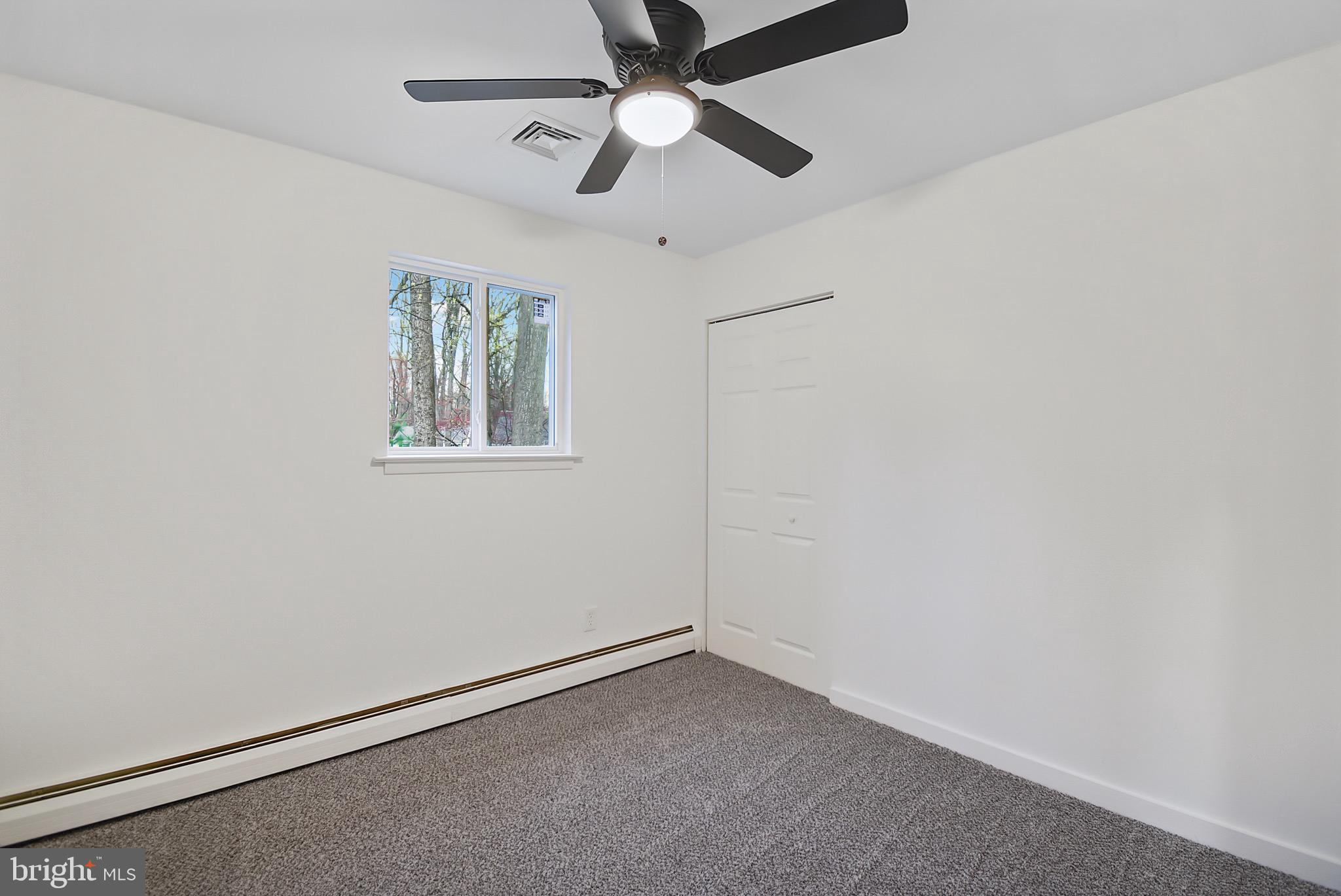 421 Concord Avenue Exton, PA 19341 - Photo 27 of 38 an empty room with a window and a fan