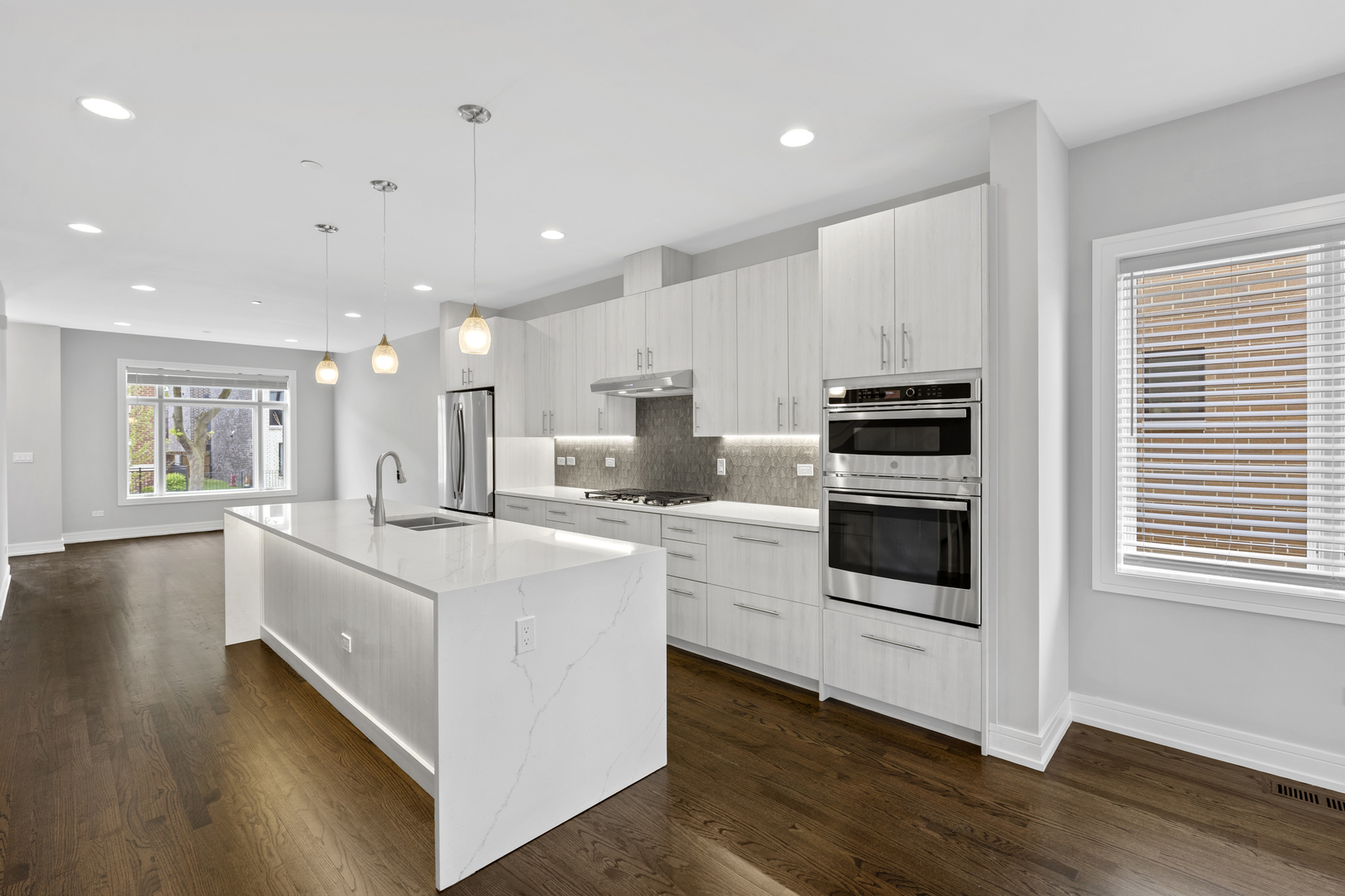 3231 South Shields Avenue Chicago, IL 60616 - Photo 13 of 58 a kitchen with stainless steel appliances kitchen island wooden floor a stove a sink and a refrigerator
