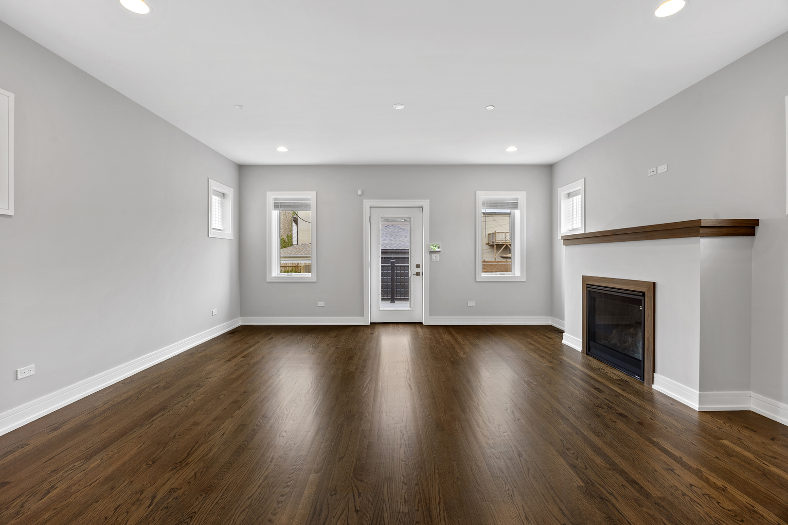 3231 South Shields Avenue Chicago, IL 60616 - Photo 18 of 58 a view of an empty room with wooden floor and a fireplace