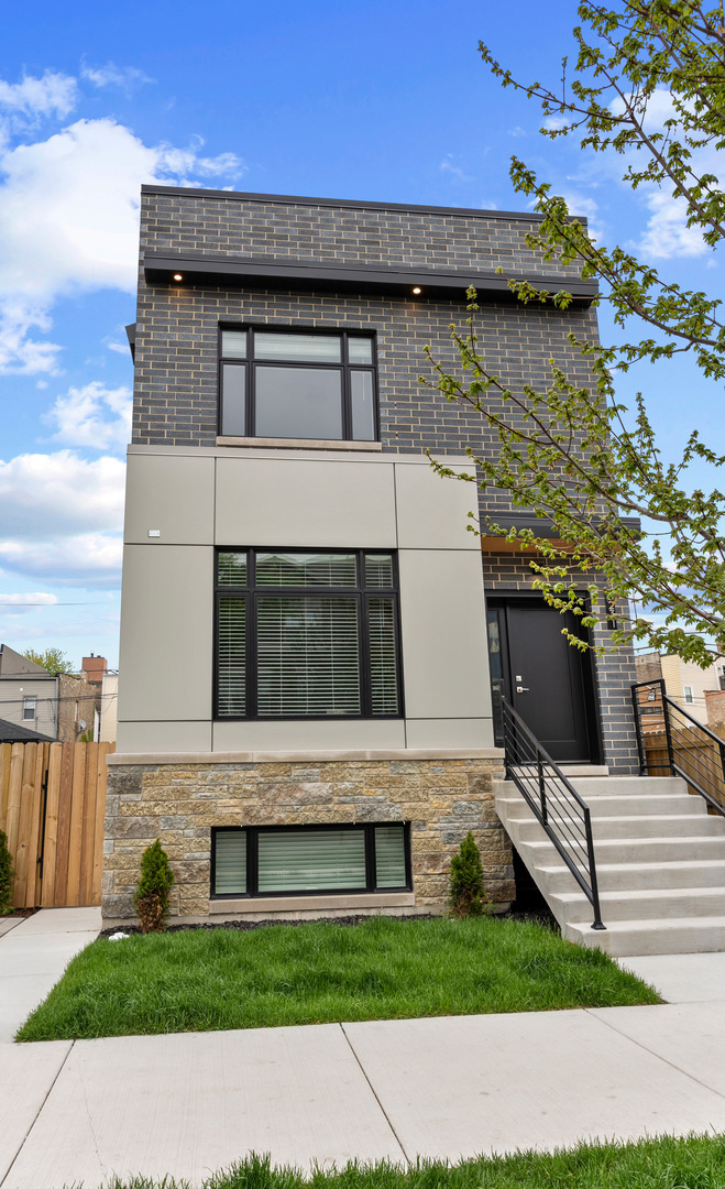 3231 South Shields Avenue Chicago, IL 60616 - Photo 2 of 58 a front view of a house with a yard