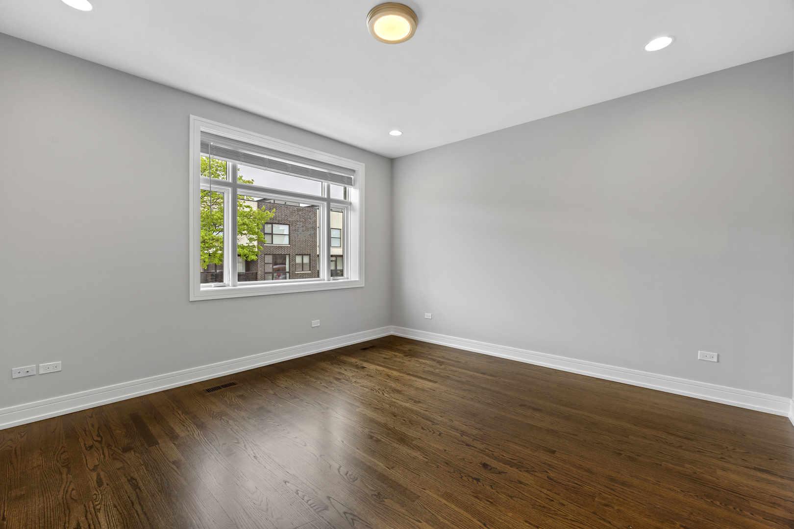 3231 South Shields Avenue Chicago, IL 60616 - Photo 23 of 58 a view of an empty room with wooden floor and a window