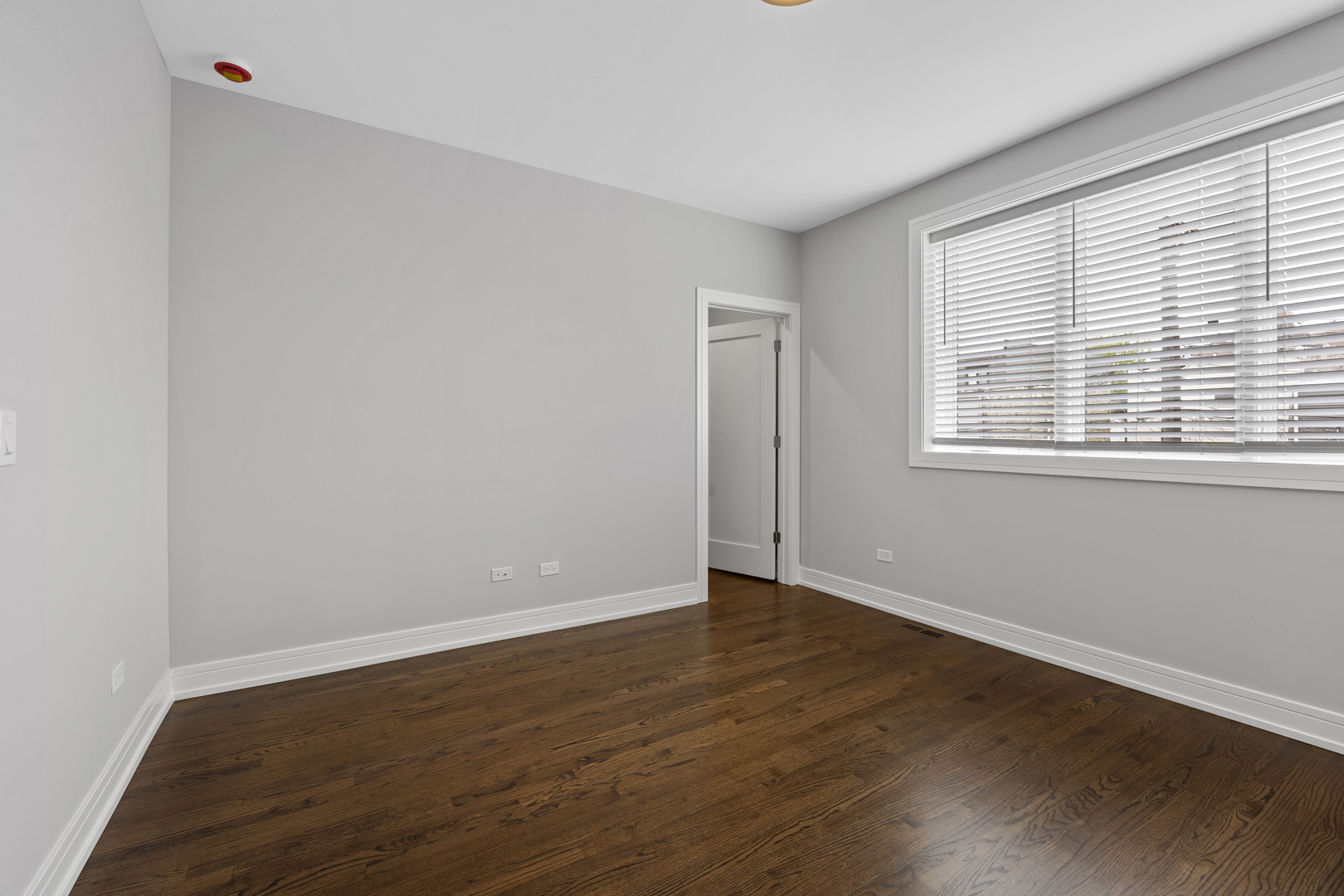 3231 South Shields Avenue Chicago, IL 60616 - Photo 31 of 58 a view of an empty room with wooden floor and a window