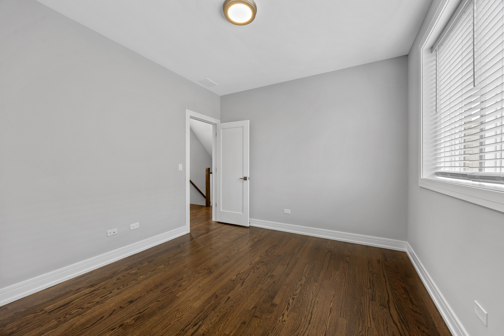 3231 South Shields Avenue Chicago, IL 60616 - Photo 32 of 58 a view of an empty room with wooden floor and a window