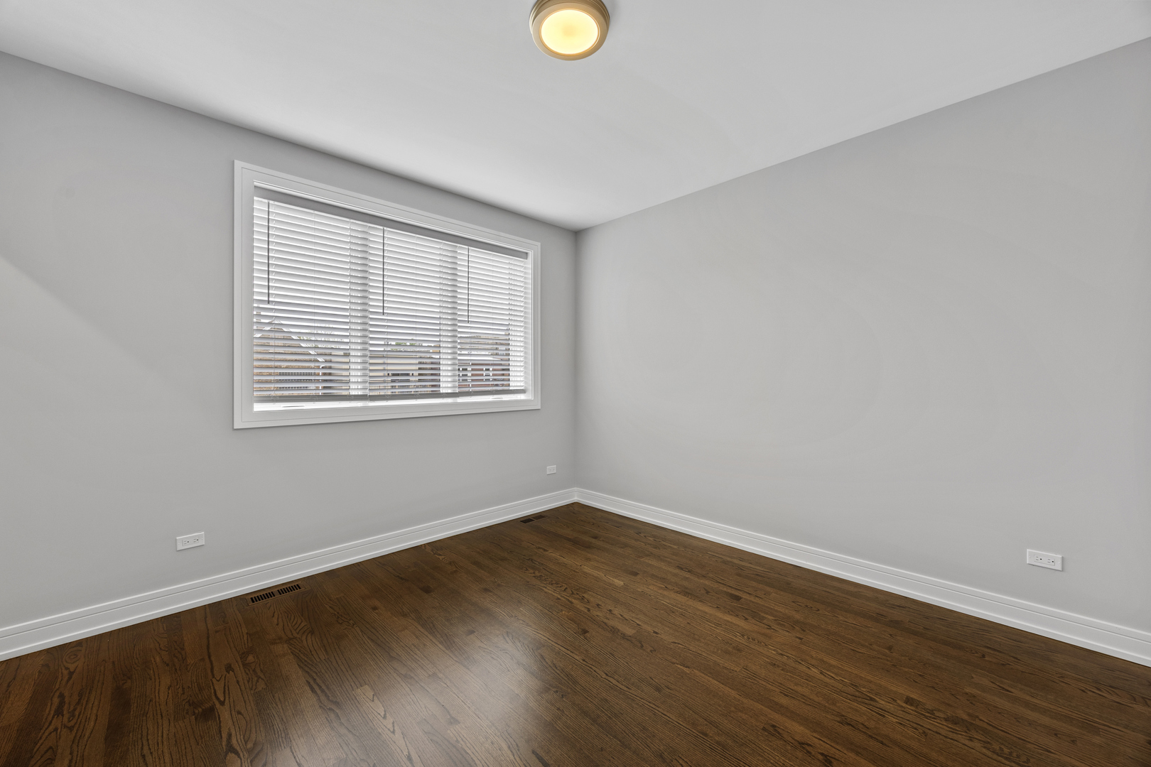 3231 South Shields Avenue Chicago, IL 60616 - Photo 34 of 58 a view of an empty room with wooden floor and a window