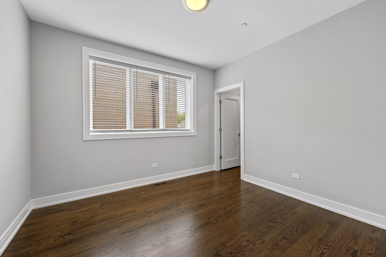 3231 South Shields Avenue Chicago, IL 60616 - Photo 35 of 58 a view of an empty room with wooden floor and a window
