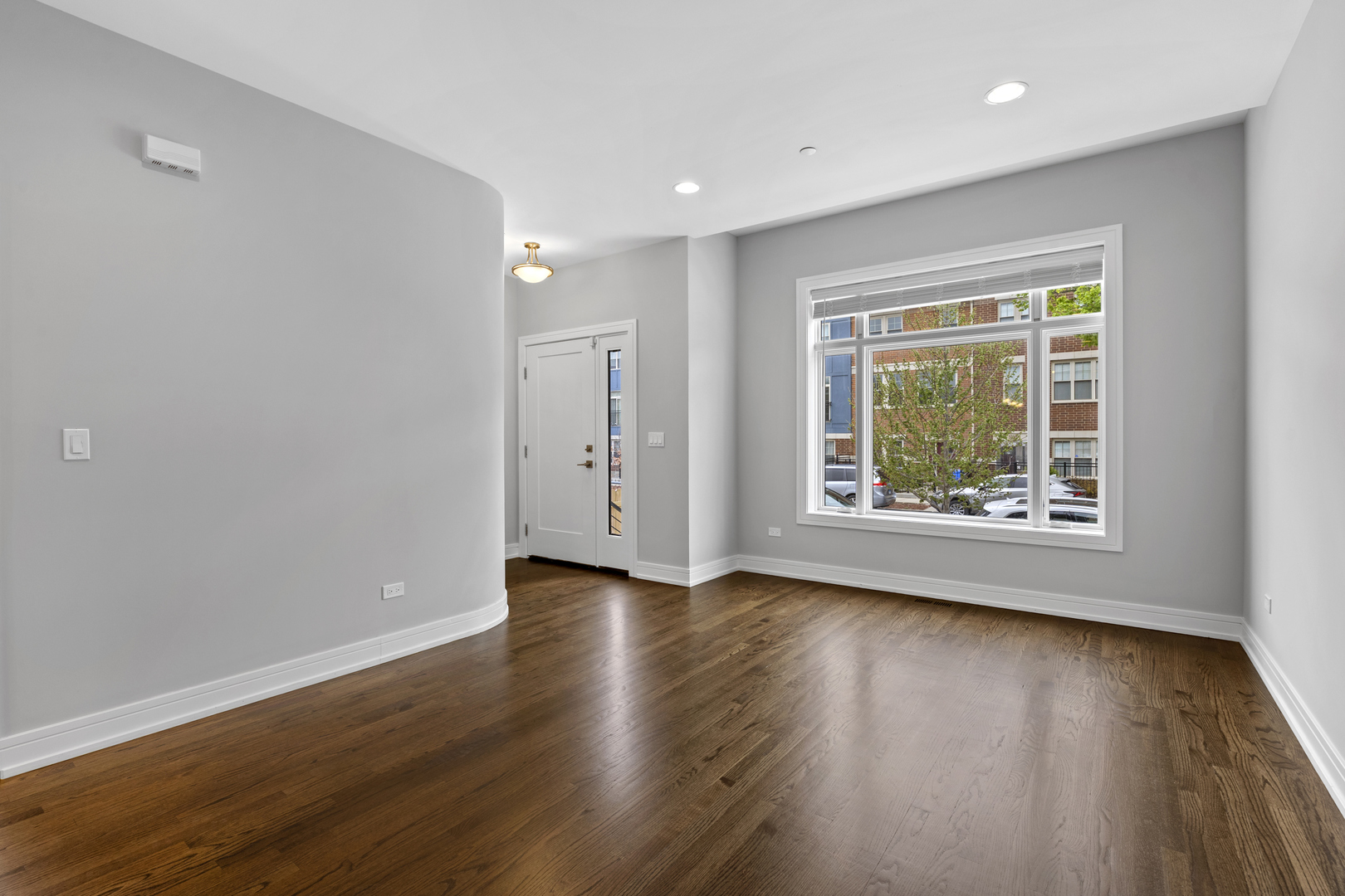 3231 South Shields Avenue Chicago, IL 60616 - Photo 5 of 58 an empty room with wooden floor and window