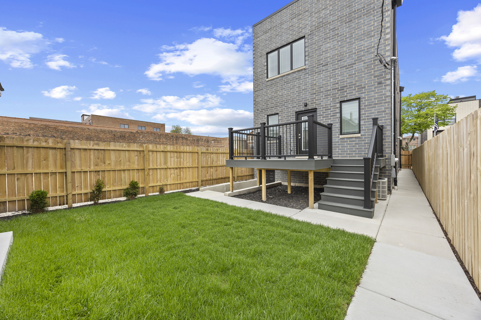 3231 South Shields Avenue Chicago, IL 60616 - Photo 56 of 58 a view of a backyard with plants and wooden fence