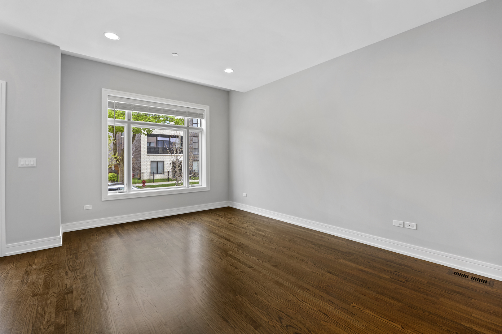 3231 South Shields Avenue Chicago, IL 60616 - Photo 6 of 58 a view of an empty room with wooden floor and a window