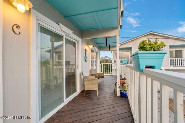 a living room with furniture and a kitchen