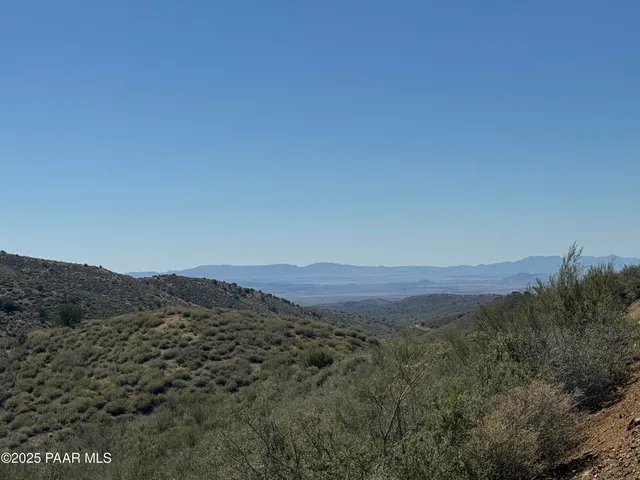 a view of a large mountain with mountains in the background
