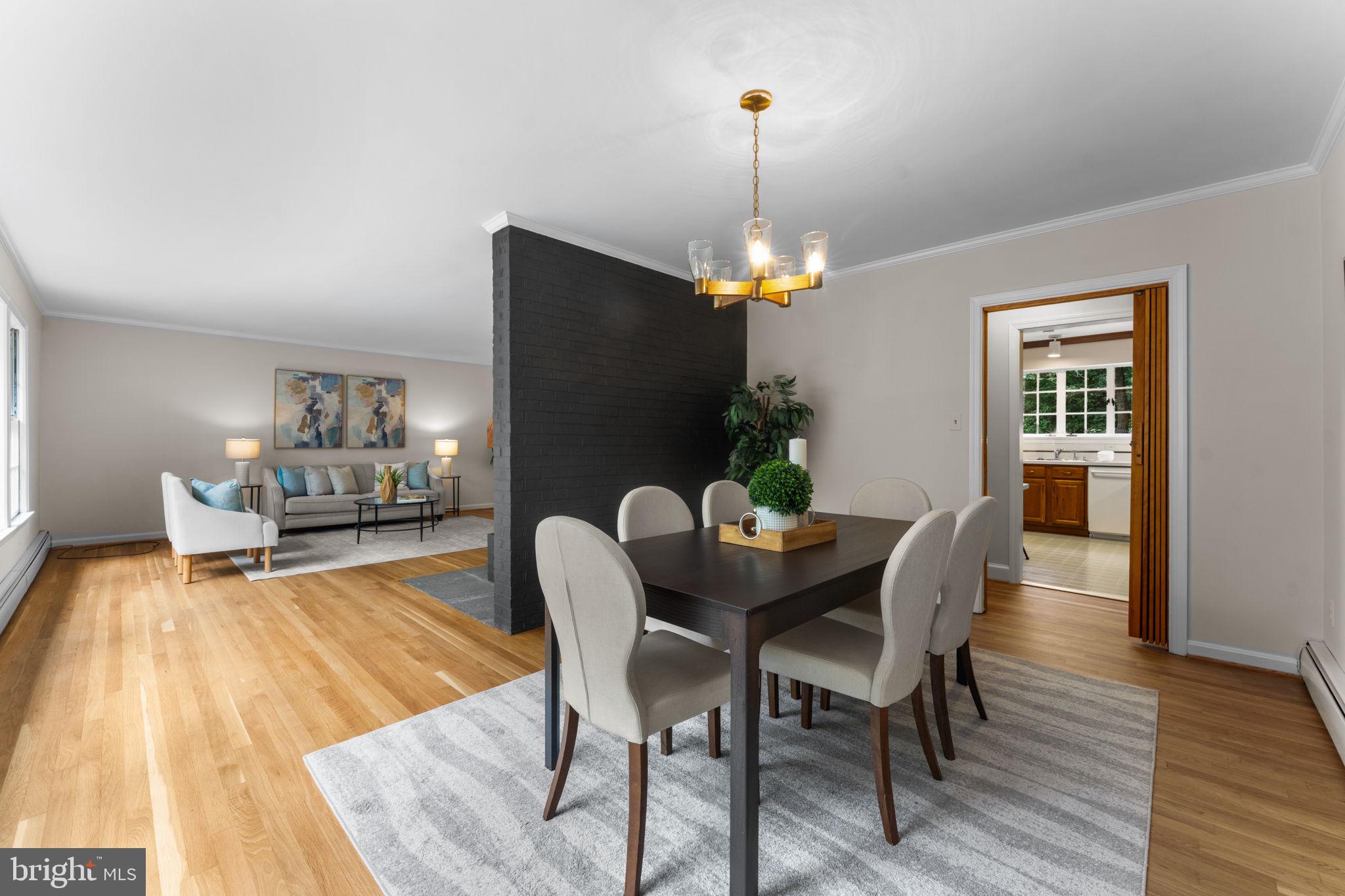 11800 Stoney Creek Road Potomac, MD 20854 - Photo 12 of 78 a dining room with furniture a chandelier and wooden floor