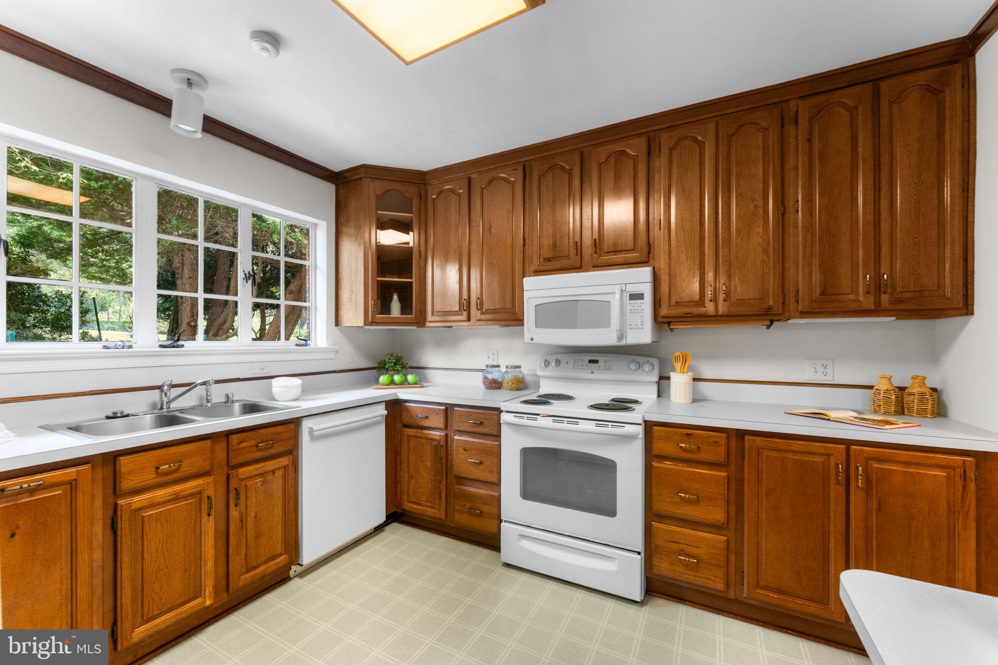 11800 Stoney Creek Road Potomac, MD 20854 - Photo 17 of 78 a kitchen with a stove sink and cabinets