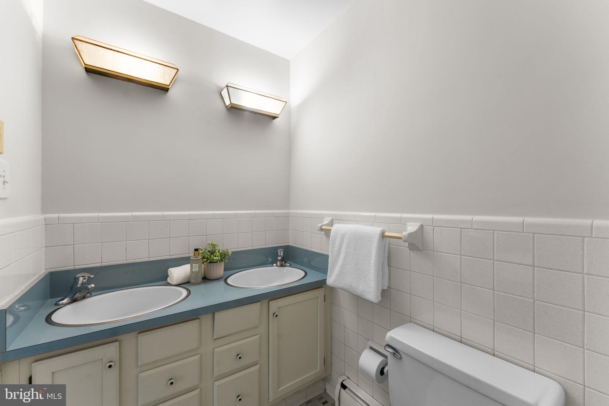 11800 Stoney Creek Road Potomac, MD 20854 - Photo 25 of 78 a bathroom with a granite countertop sink a toilet and a mirror
