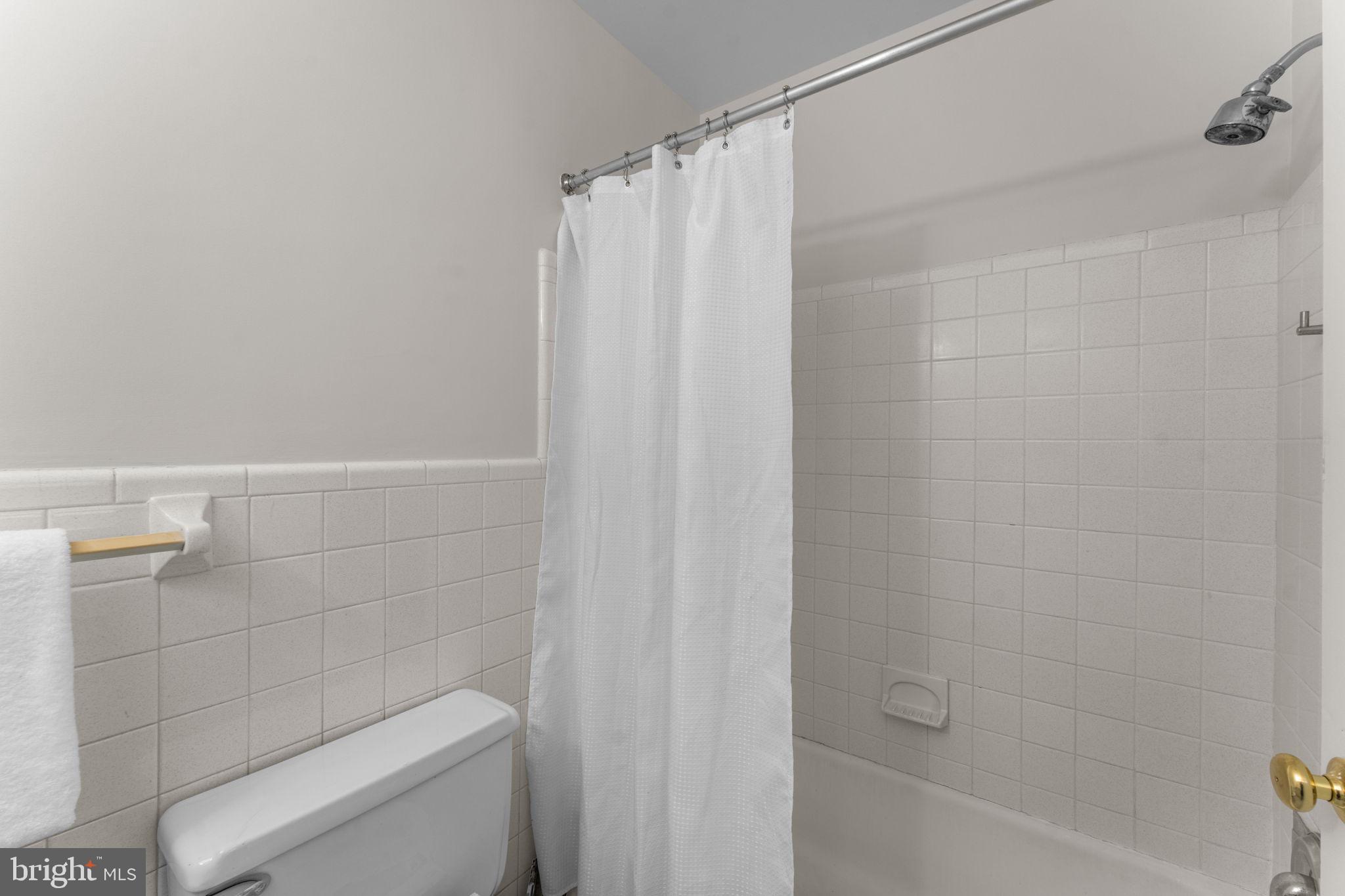 11800 Stoney Creek Road Potomac, MD 20854 - Photo 26 of 78 a bathroom with a shower and a toilet