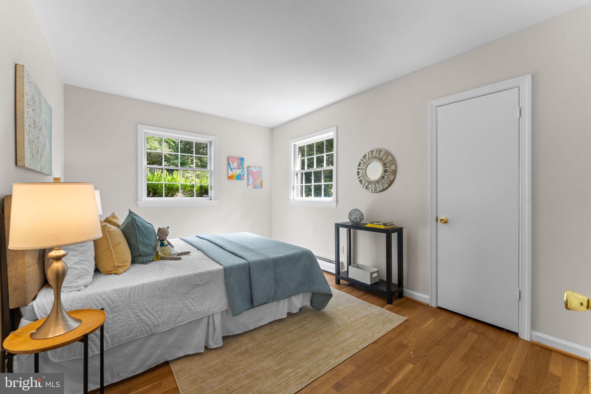11800 Stoney Creek Road Potomac, MD 20854 - Photo 28 of 78 a bedroom with a bed a dresser with chair and window