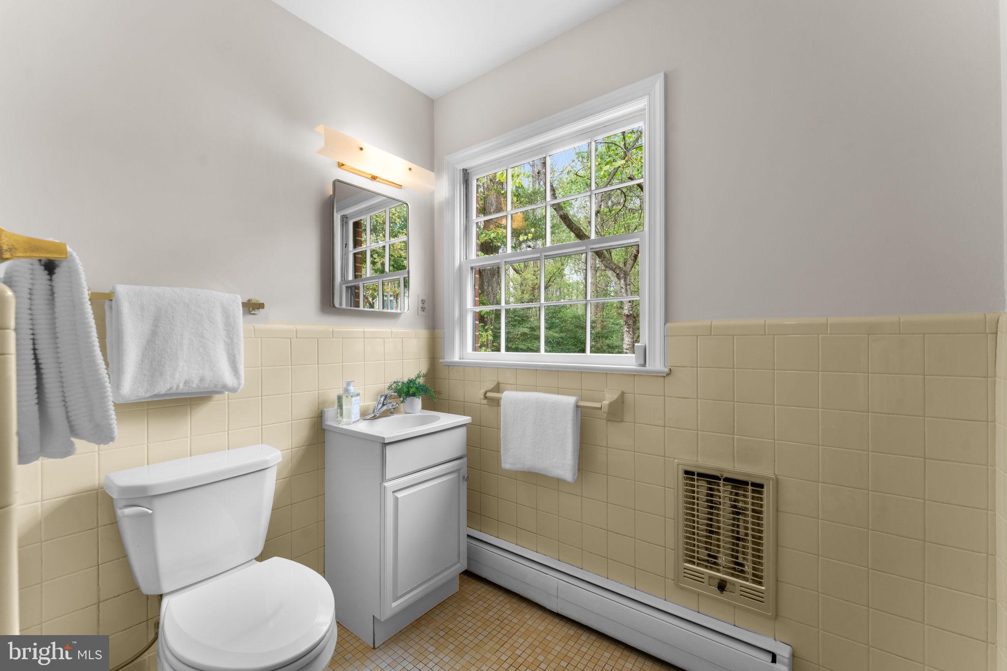 11800 Stoney Creek Road Potomac, MD 20854 - Photo 33 of 78 a bathroom with a sink toilet vanity and window