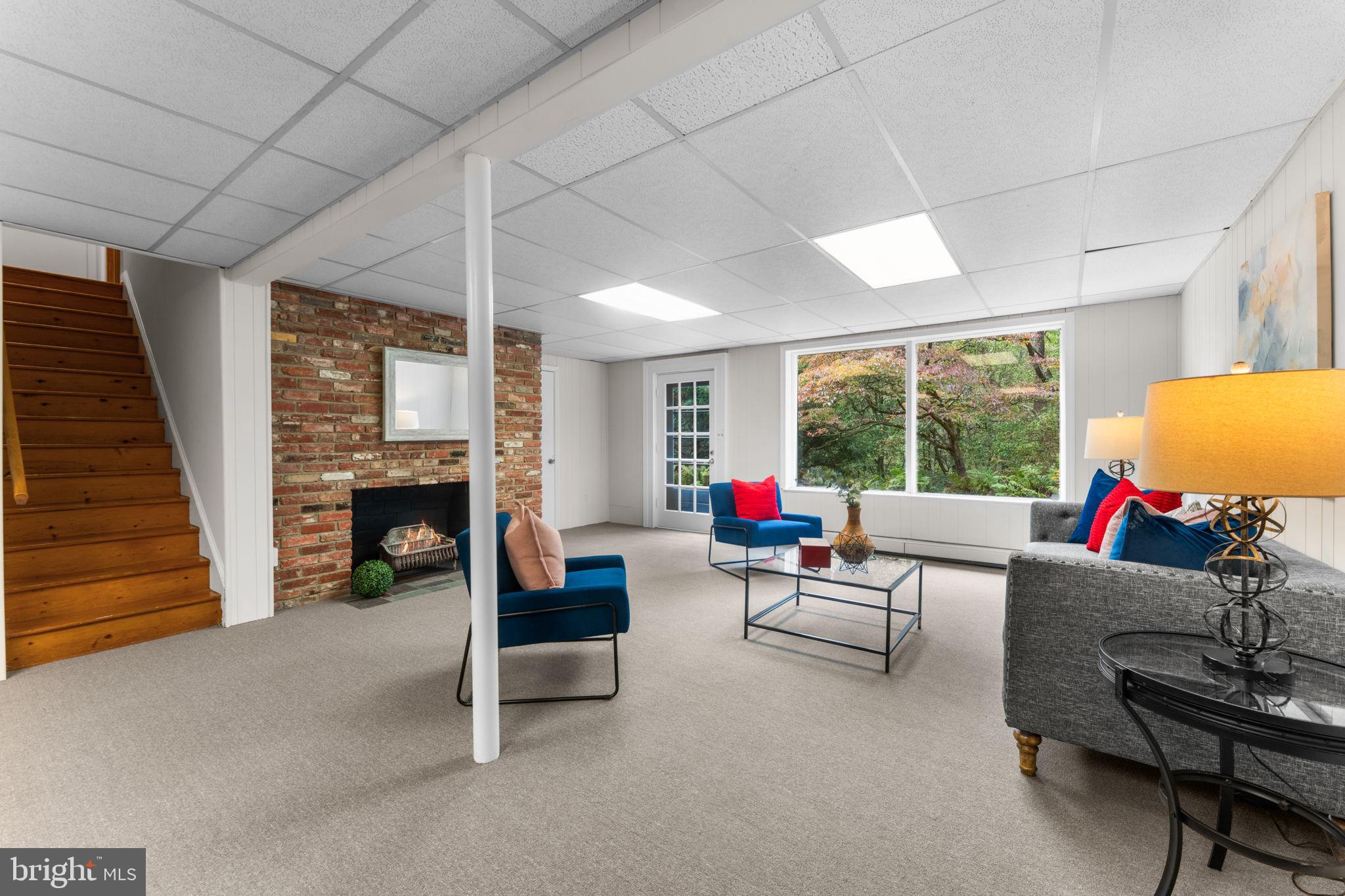 11800 Stoney Creek Road Potomac, MD 20854 - Photo 35 of 78 a living room with furniture and a fireplace