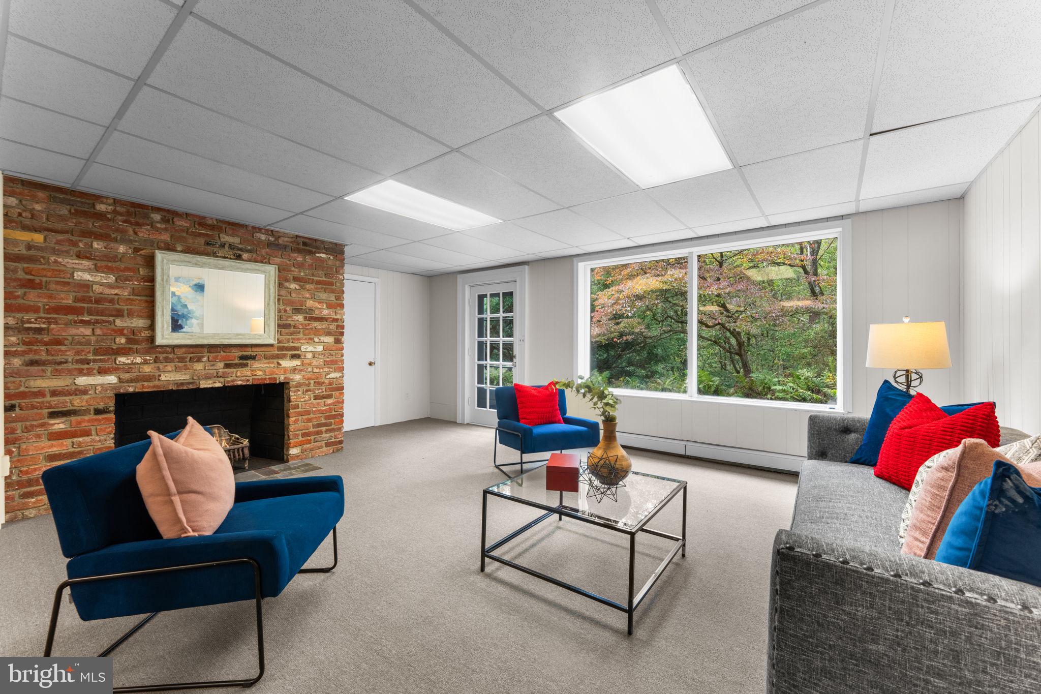 11800 Stoney Creek Road Potomac, MD 20854 - Photo 36 of 78 a living room with furniture and a fireplace