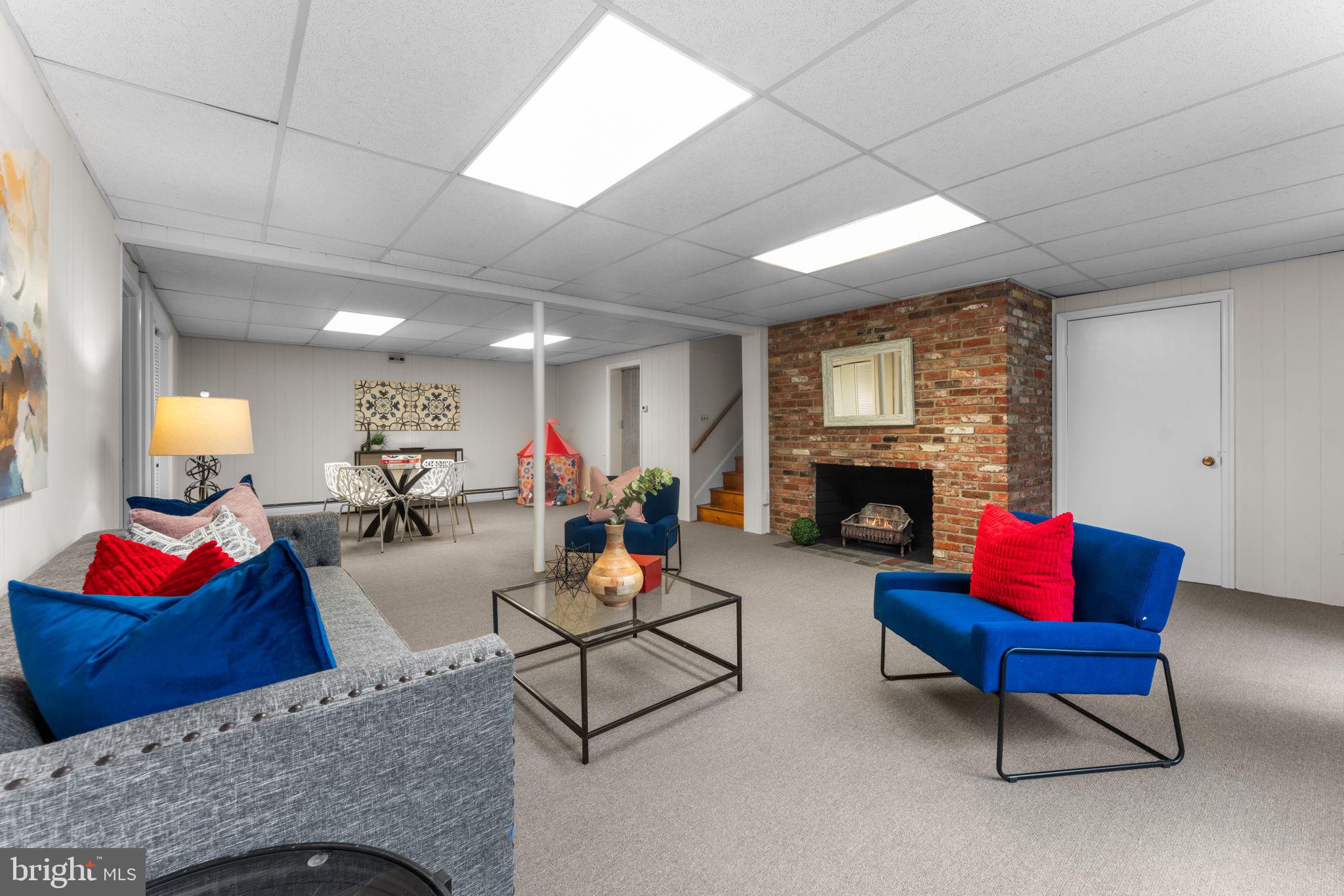 11800 Stoney Creek Road Potomac, MD 20854 - Photo 38 of 78 a living room with furniture and a fireplace