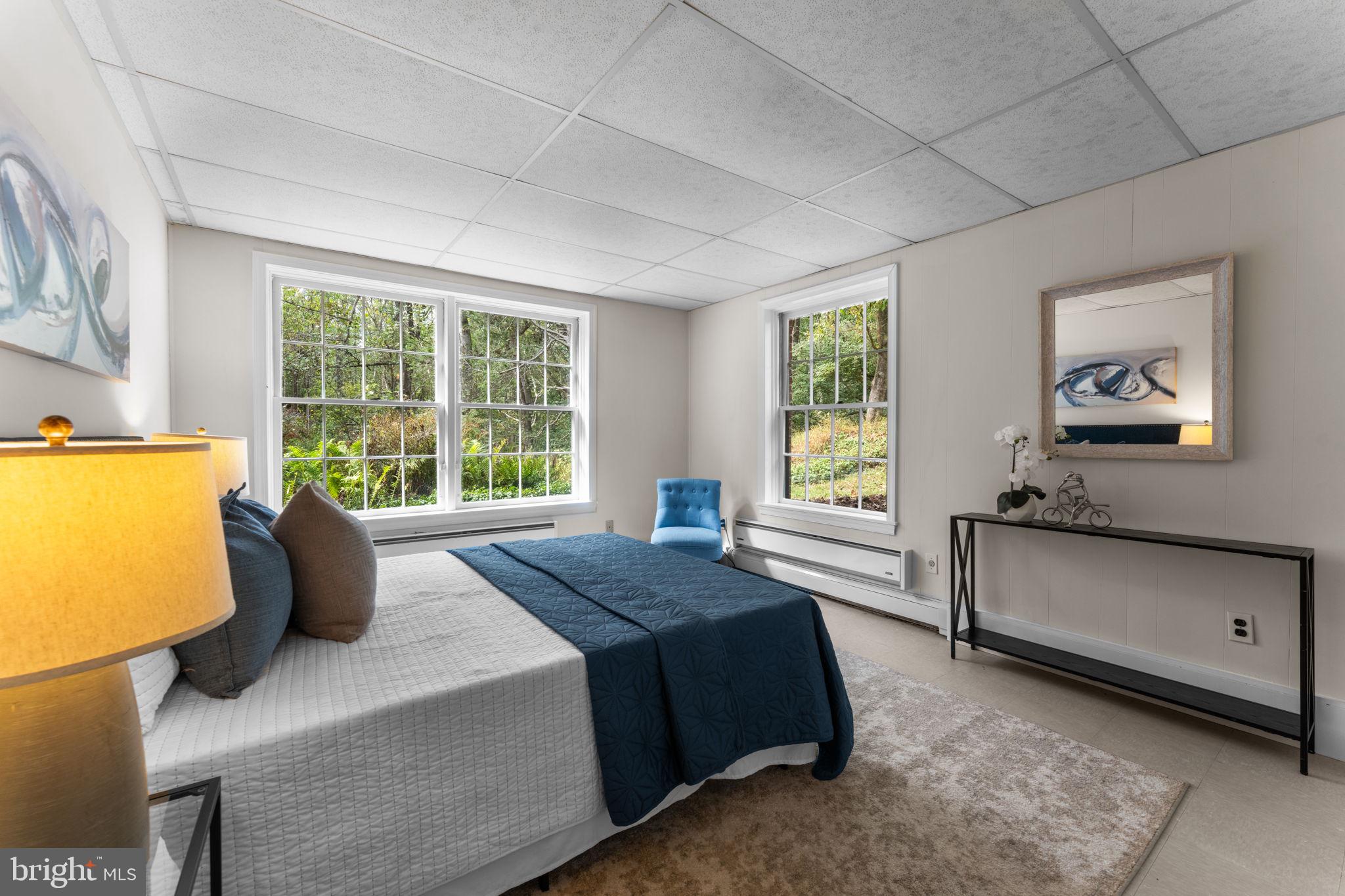 11800 Stoney Creek Road Potomac, MD 20854 - Photo 41 of 78 a spacious bedroom with a bed and wooden floor