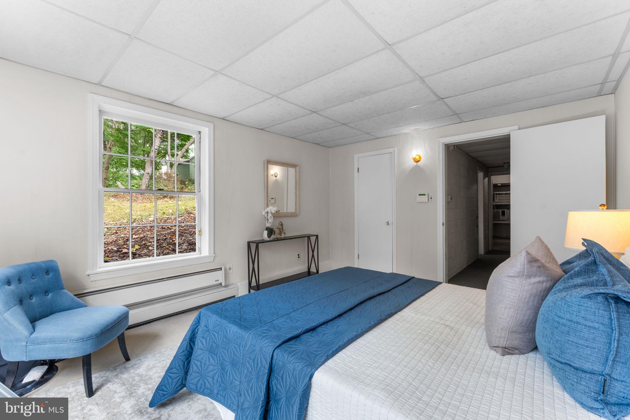 11800 Stoney Creek Road Potomac, MD 20854 - Photo 44 of 78 a bedroom with a large bed and a couch