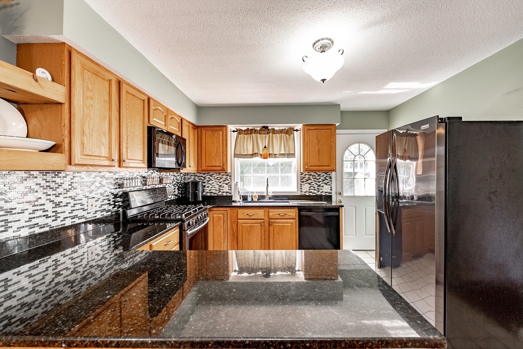 116 Garland Street Springfield, MA 01118 - Photo 11 of 31 a kitchen with granite countertop lots of counter top space and stainless steel appliances