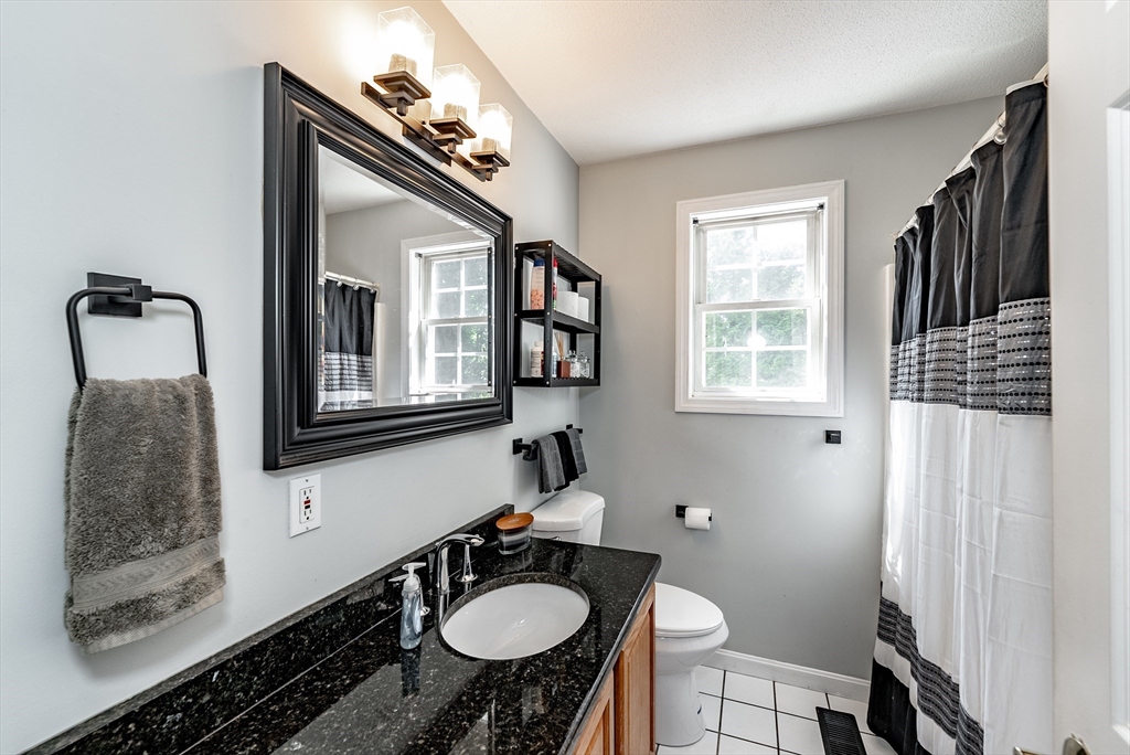 116 Garland Street Springfield, MA 01118 - Photo 14 of 31 a bathroom with a sink toilet and a mirror