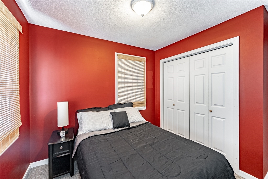 116 Garland Street Springfield, MA 01118 - Photo 16 of 31 a bedroom with a bed and a lamp