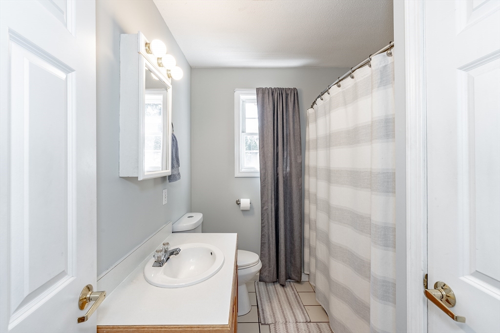 116 Garland Street Springfield, MA 01118 - Photo 20 of 31 a bathroom with a sink a mirror and a shower
