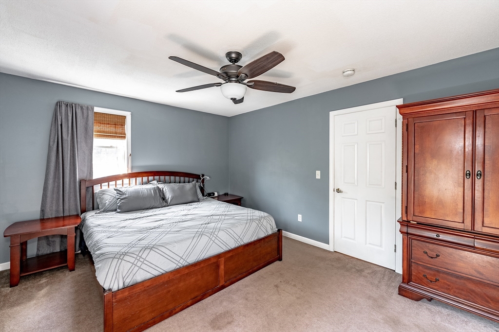 116 Garland Street Springfield, MA 01118 - Photo 21 of 31 a bedroom with a large bed and a chandelier