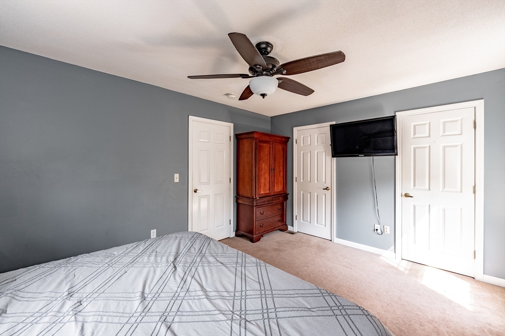 116 Garland Street Springfield, MA 01118 - Photo 22 of 31 a bedroom with a large bed and a chandelier