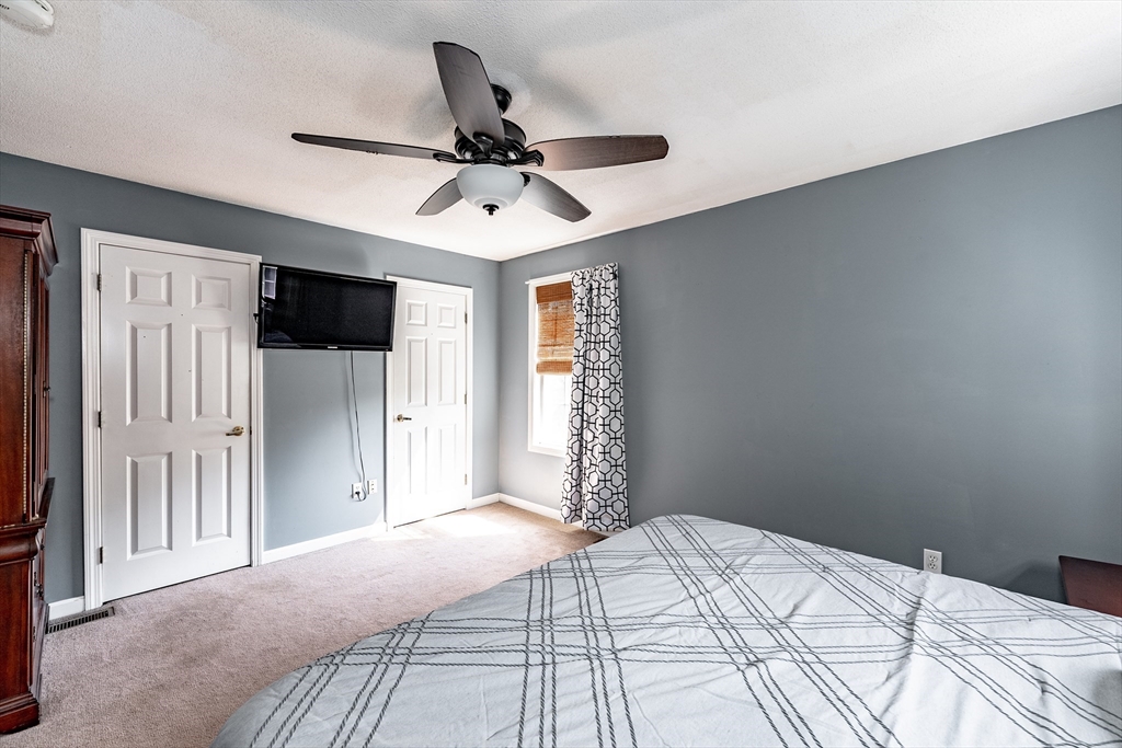 116 Garland Street Springfield, MA 01118 - Photo 23 of 31 a bedroom with a large bed and a chandelier