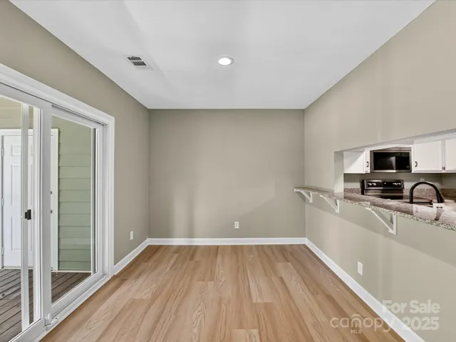 a view of a kitchen with a sink and a refrigerator