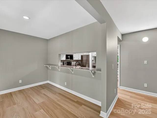 a view of a kitchen with a sink and a refrigerator