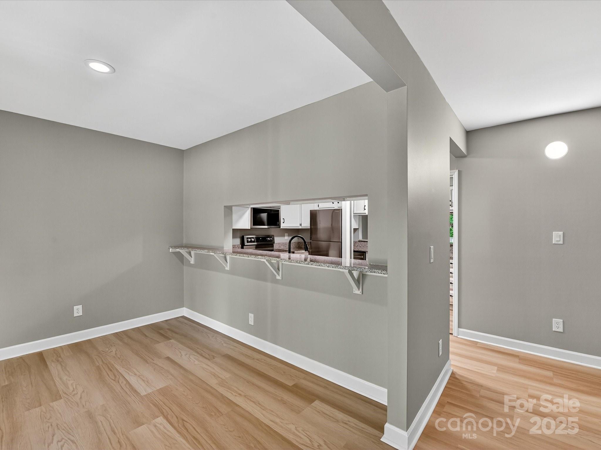 20115 Henderson Road, Unit D Cornelius, NC 28031 - Photo 13 of 44 a view of a kitchen with a sink and a refrigerator