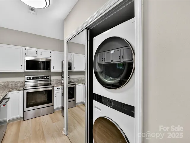 a kitchen with a stove a washer and dryer