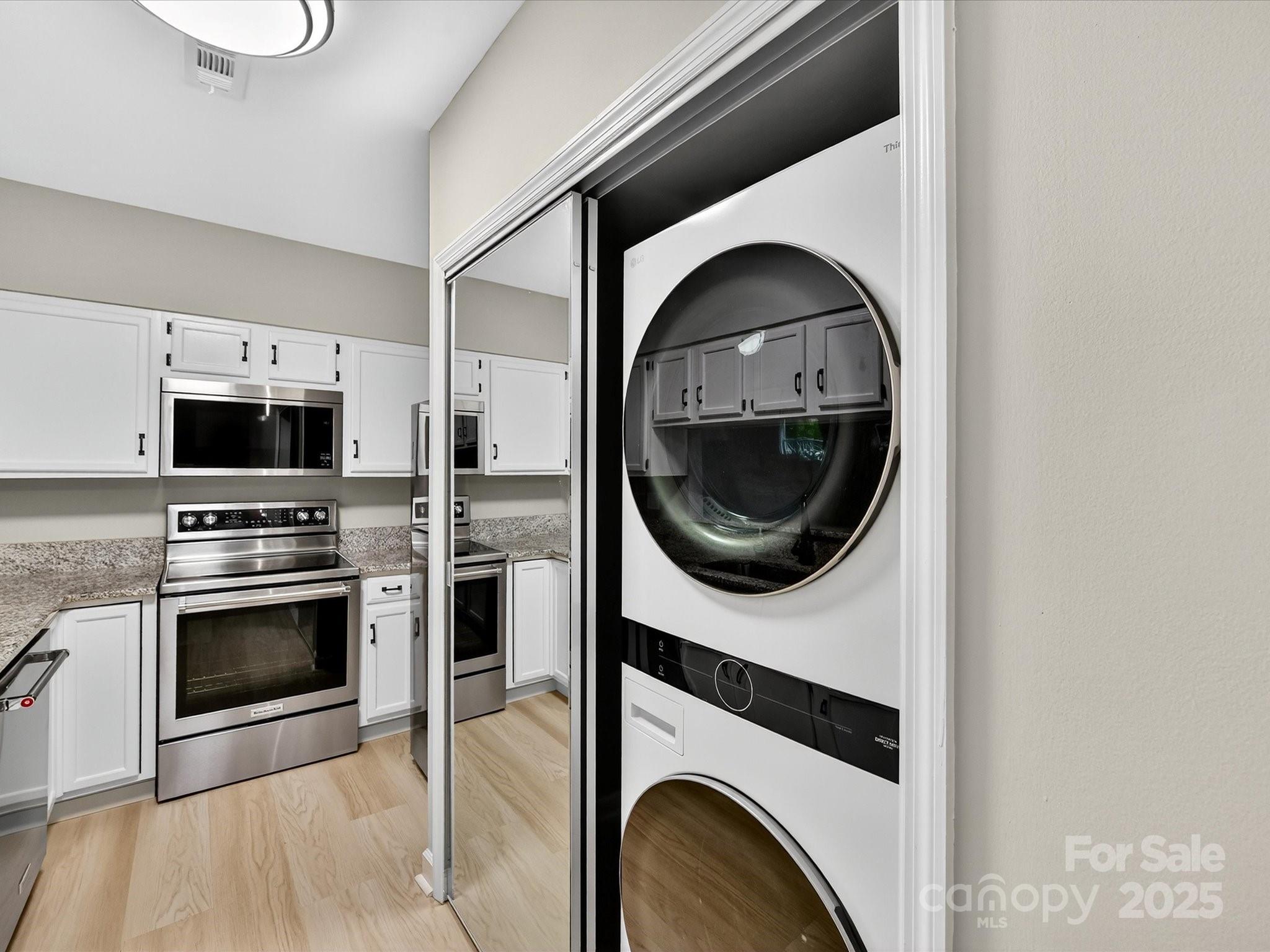 20115 Henderson Road, Unit D Cornelius, NC 28031 - Photo 14 of 44 a kitchen with a stove a washer and dryer