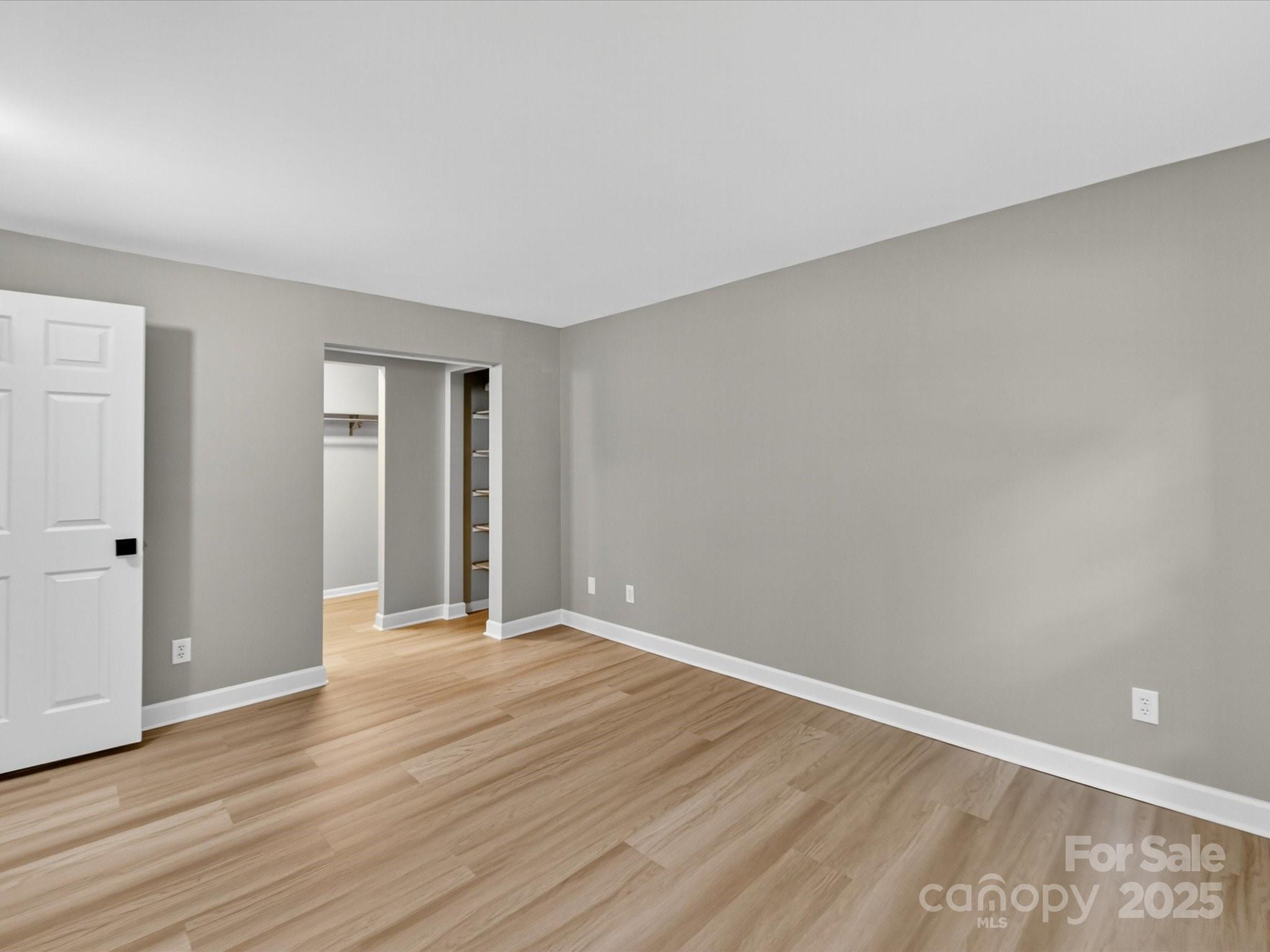 20115 Henderson Road, Unit D Cornelius, NC 28031 - Photo 16 of 44 a view of an empty room with wooden floor and closet