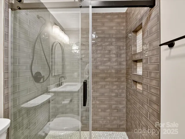a bathroom with a shower and a sink