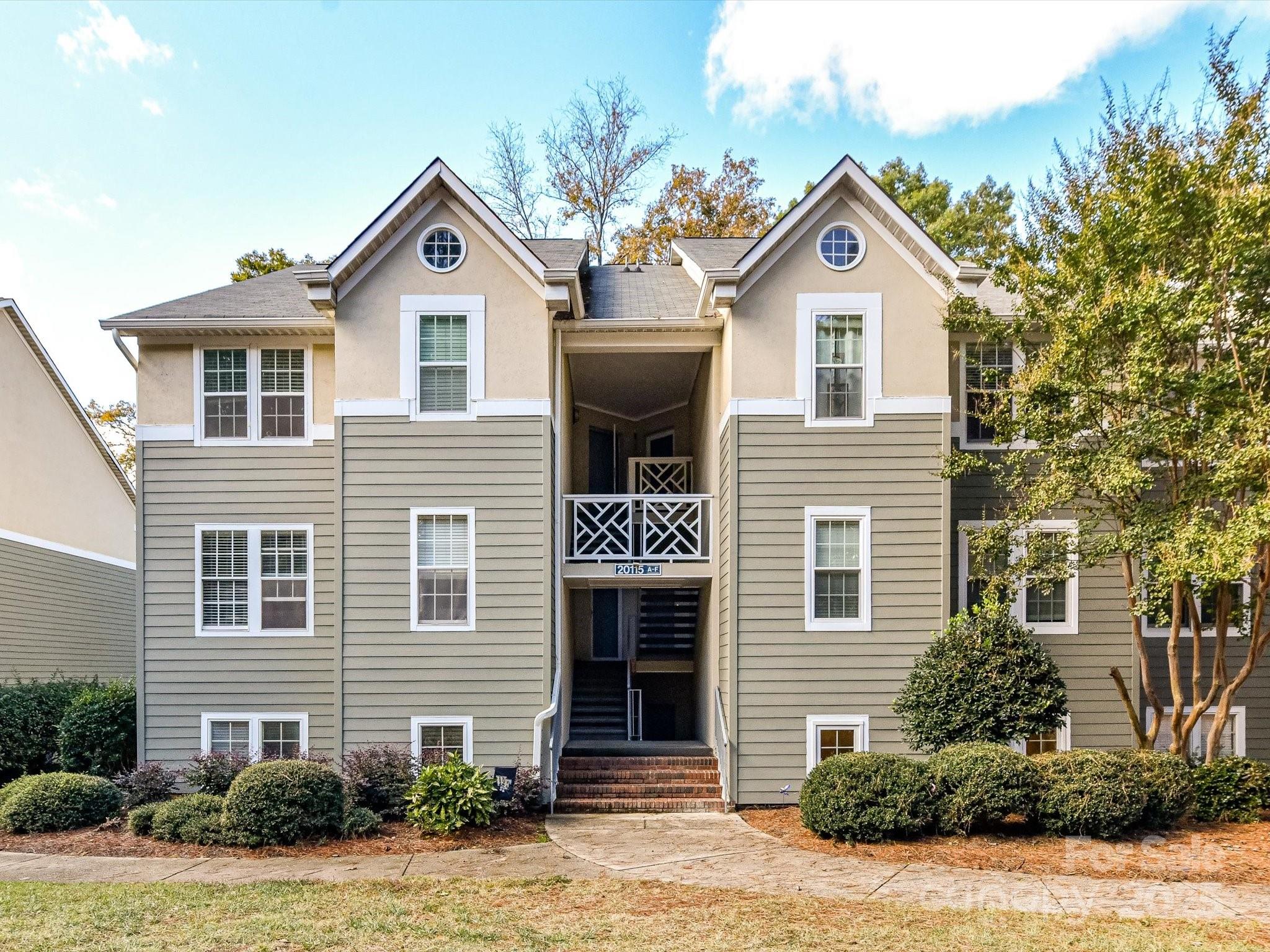 20115 Henderson Road, Unit D Cornelius, NC 28031 - Photo 2 of 44 a front view of a house with yard and green space