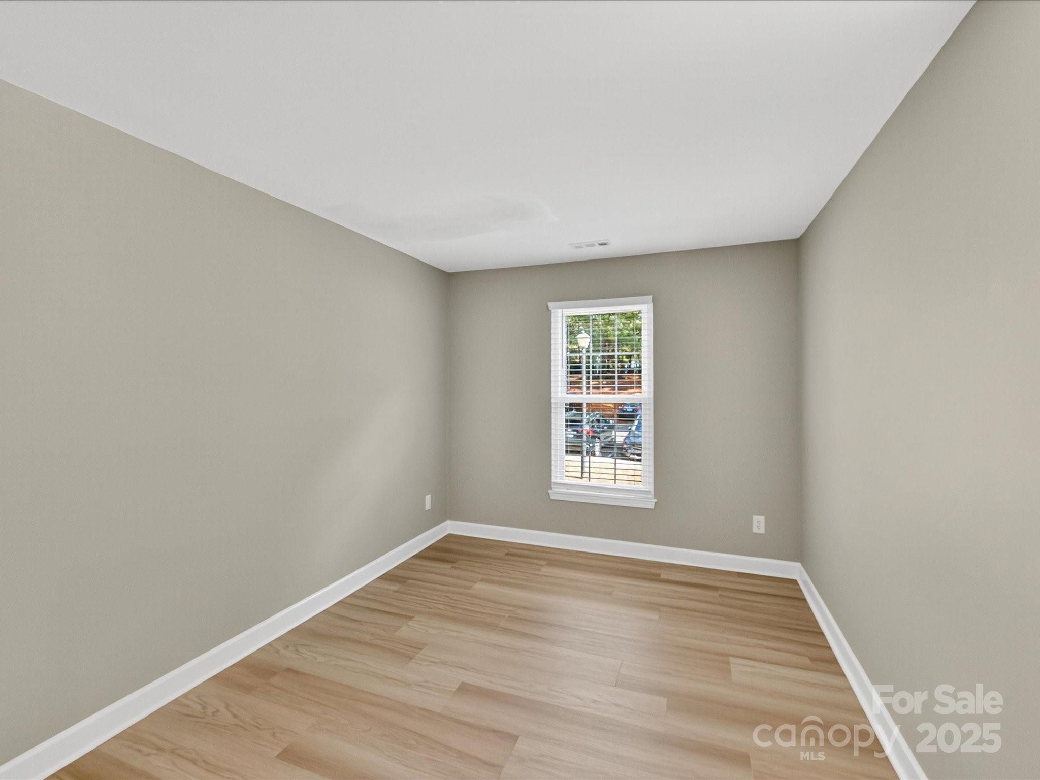 20115 Henderson Road, Unit D Cornelius, NC 28031 - Photo 22 of 44 an empty room with wooden floor and windows