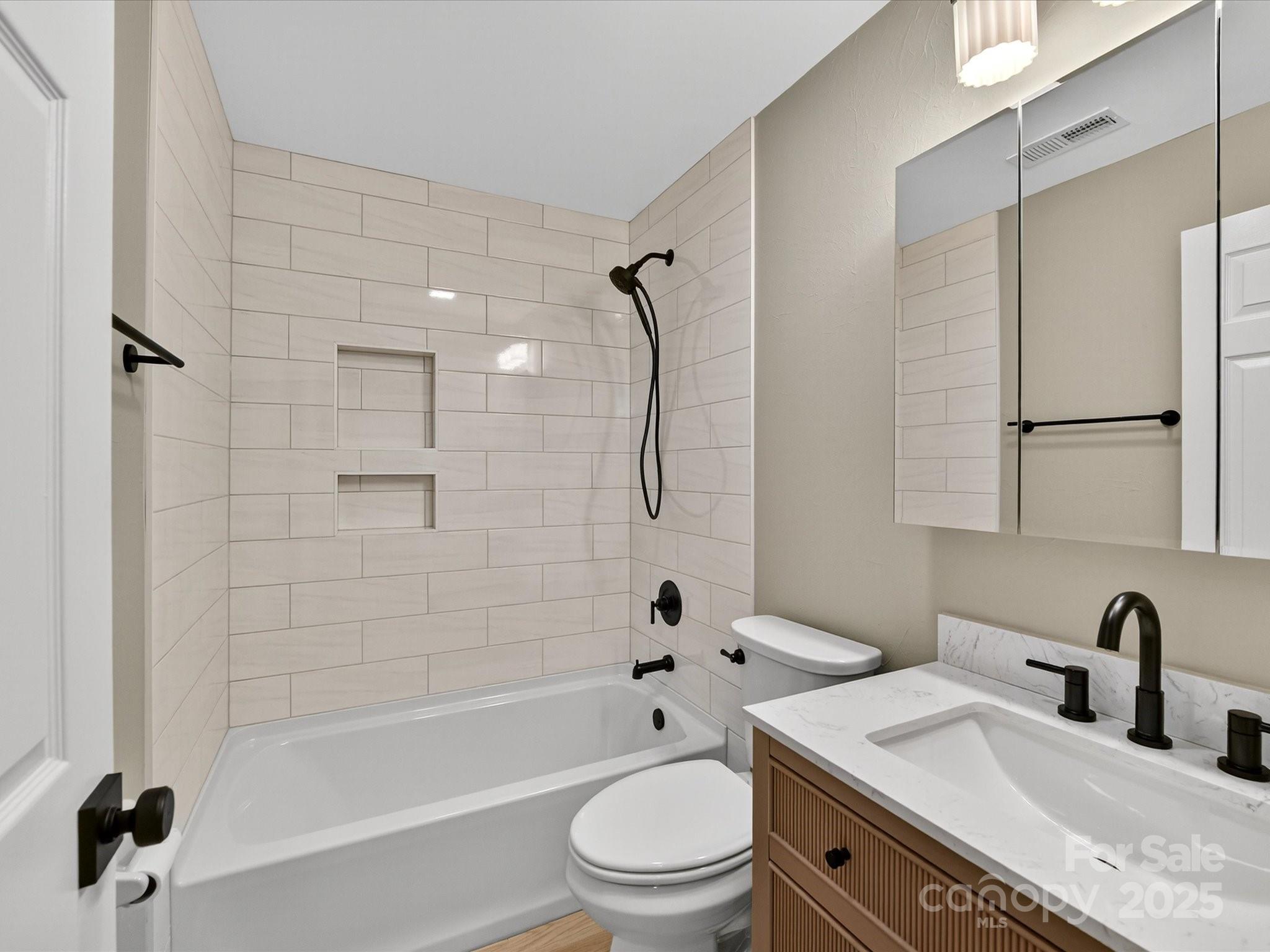 20115 Henderson Road, Unit D Cornelius, NC 28031 - Photo 24 of 44 a bathroom with a granite countertop sink a toilet and shower