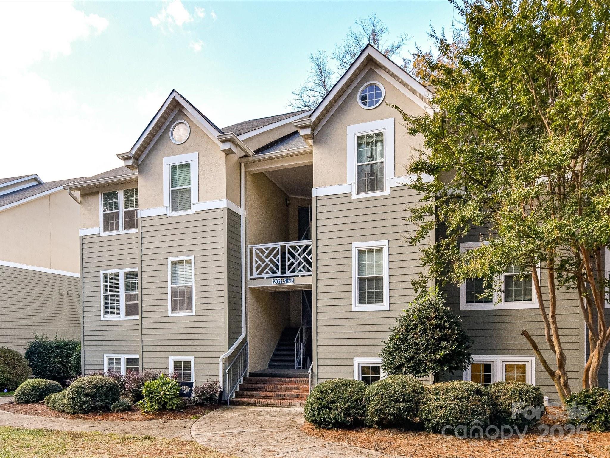 20115 Henderson Road, Unit D Cornelius, NC 28031 - Photo 3 of 44 a front view of a house with a yard and garage