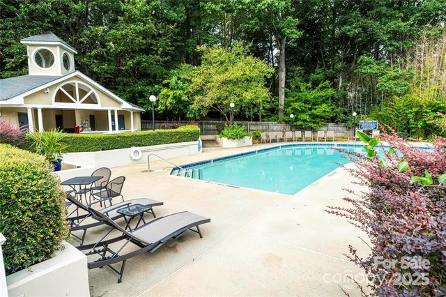 a view of a house with swimming pool and sitting area