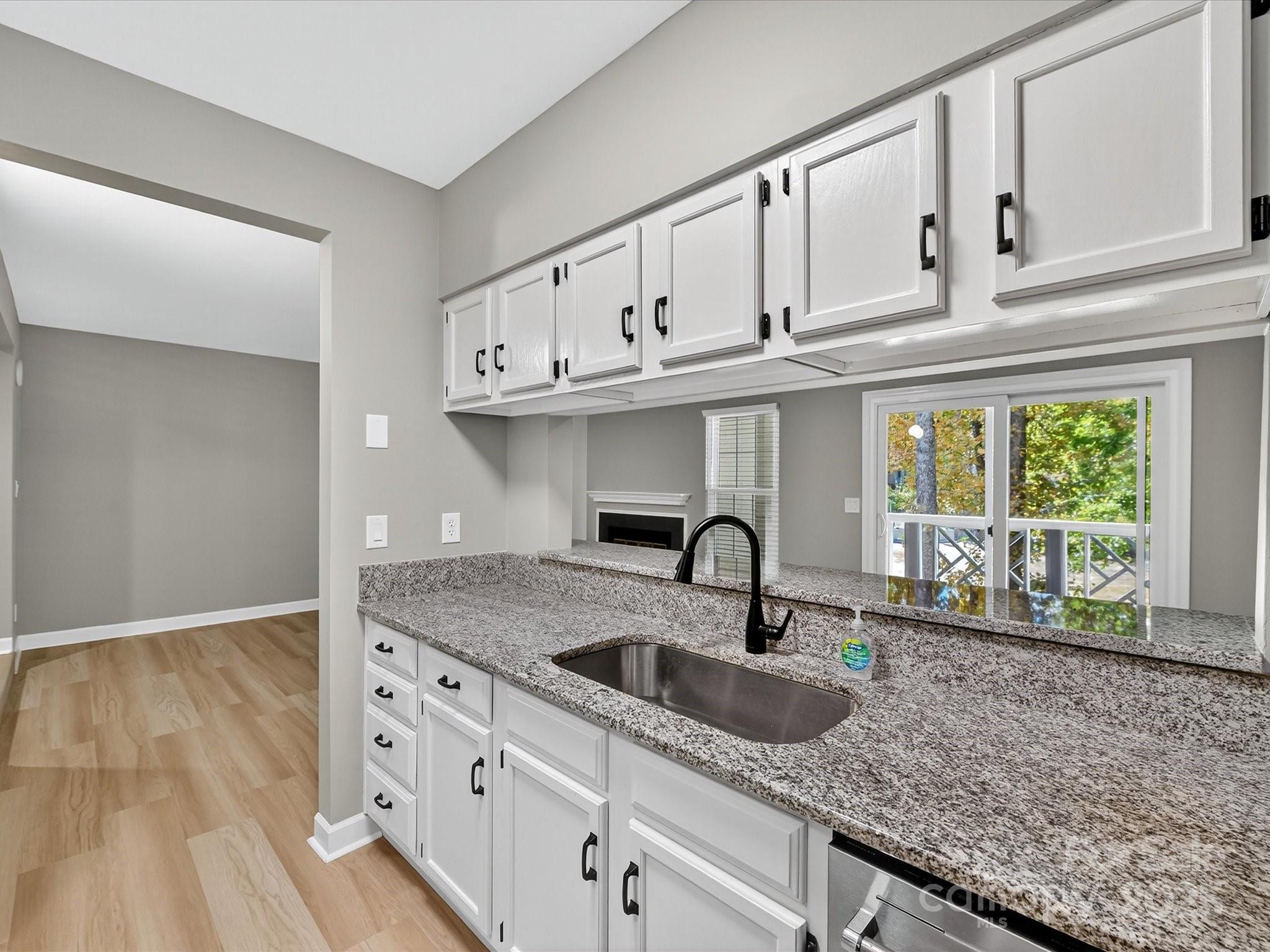 20115 Henderson Road, Unit D Cornelius, NC 28031 - Photo 10 of 44 a kitchen with granite countertop a sink and cabinets